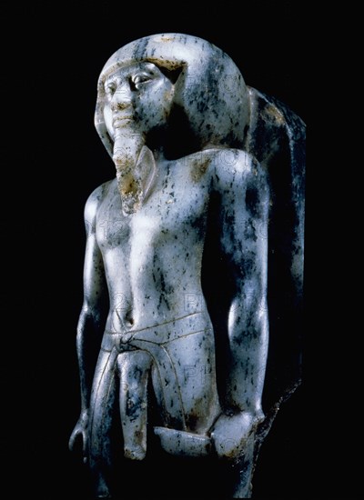 Statue of a striding god, in human form, holding a ceremonial knife