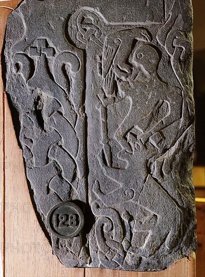 The Andreas Stone with a relief depicting a scene from the legendary Norse poem Ragnarok, Doomsday of the Gods, in which the god Odin is eaten by the wolf Fenrir