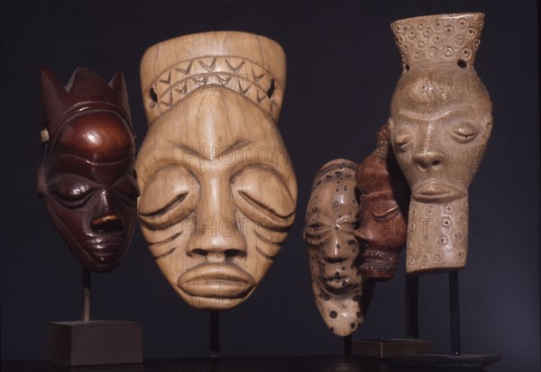 Miniature ivory pendant masks worn by Pende men to indicate successful completion of rites associated with circumcision, and hence transition to adult status