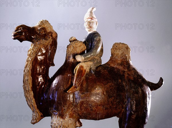 Sancai glazed tomb figure of a camel and foreign rider with an exaggeratedly large nose