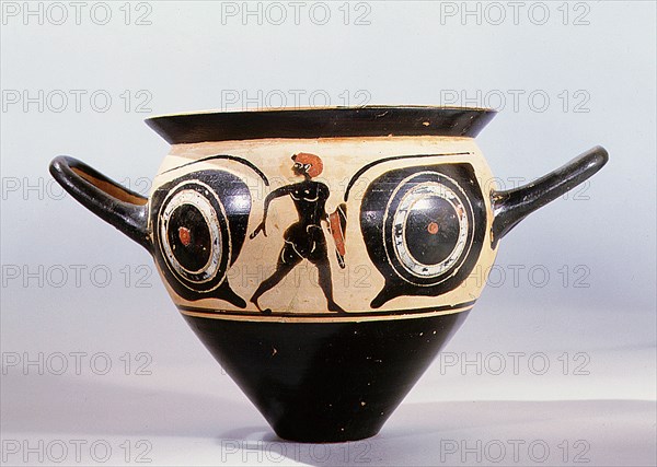 Attic black figure mastoid cup, the painted scene depicting a large pair of eyes, between them a naked youth holding a red cloak