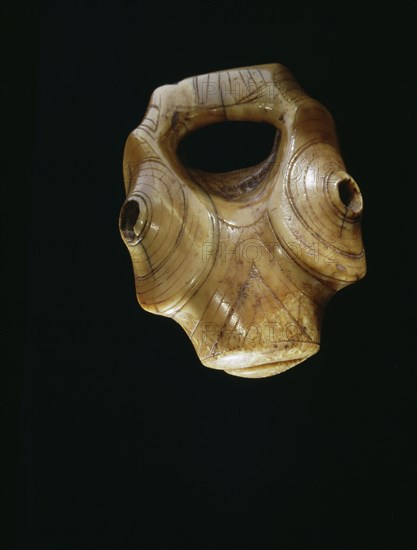 Ivory object carved with an abstract animal face