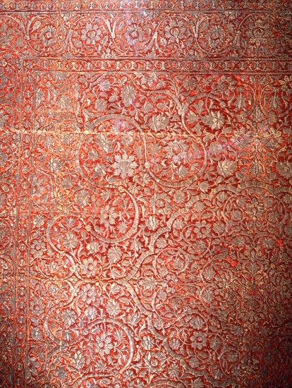 Red silk carpet with heavy silver arabesque designs