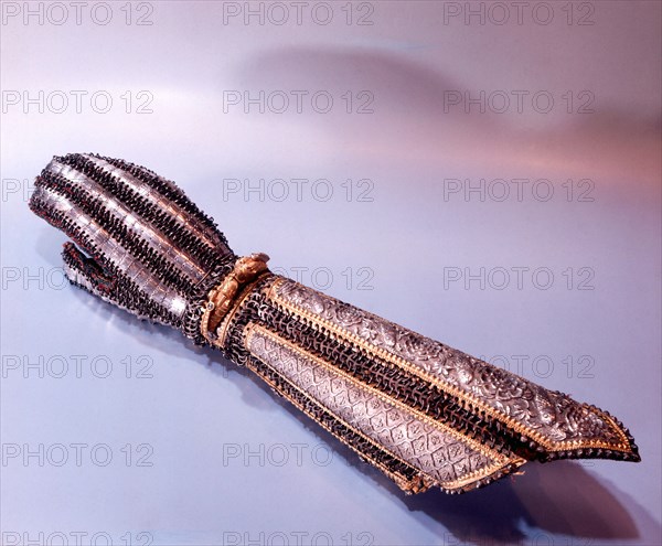 A gauntlet of a Rajasthani prince which is adorned with a gold bracelet in the form of two dragons with eyes of ruby and sapphire