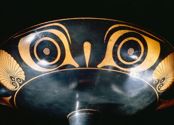 Attic, bilingual, eye cup with black figure interior depicting running minotaur and inscription reading the boy is beautiful