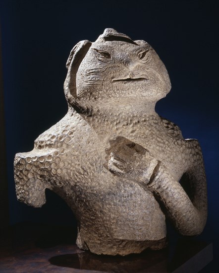 Dogu figure in the form of a human torso with the left arm across the breast