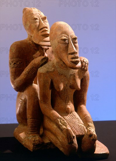 Terracotta figures of a man seated behind a woman