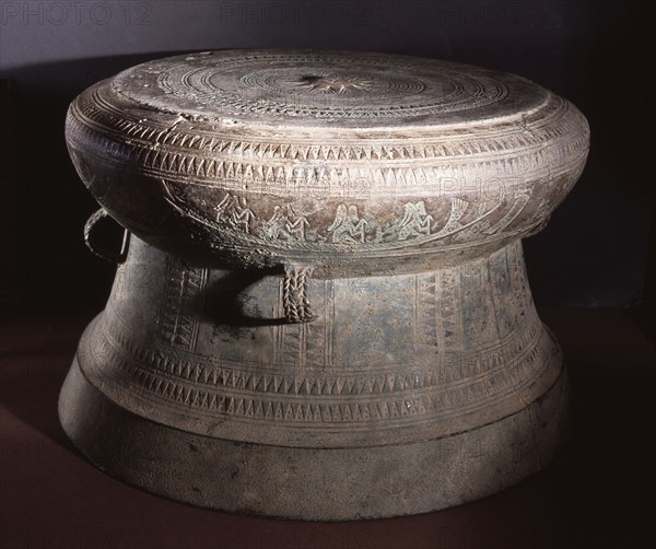 Detail of decoration on a Dong Son drum, depicting figures with feathered headdresses in a boat