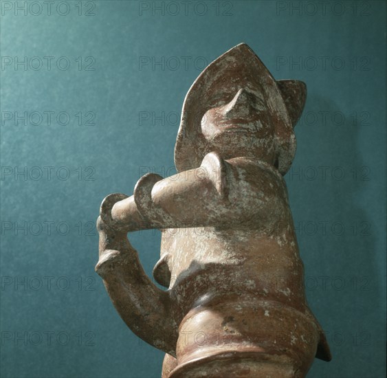 Standing ithyphallic figure, holding phallus