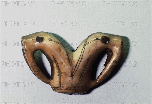 Ivory ornament depicting two walrus heads