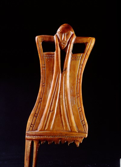 Comb in the shape of a stylized female figure with incised decorations