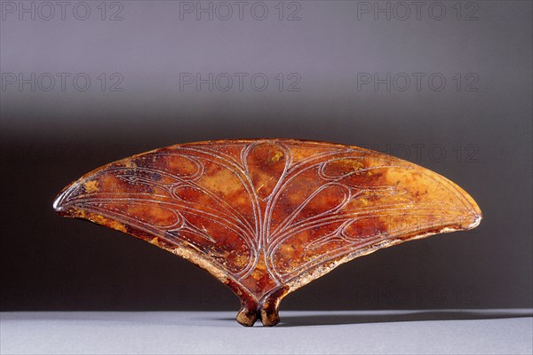 Fan shaped ivory object with incised decoration