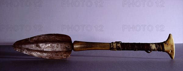 Butchering knife with a blade of hand beaten native copper and a handle made from two pieces of bone lashed together with sealskin