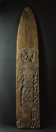 Pohu, or war gong, fashioned from a hollow tree, leaving a suspended tongue of plain wood at the base to be struck