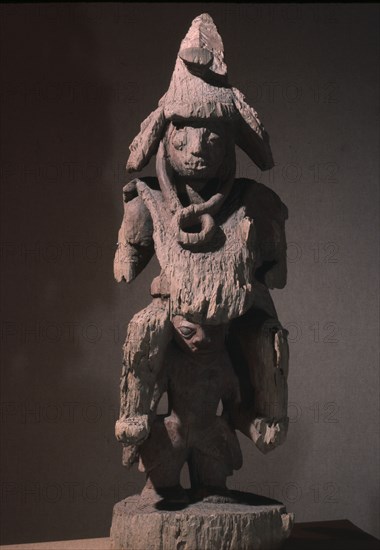 A shrine figure depicting a warrior in the full battle dress of the 19th century, Yoruba wars carried on the shoulders of a retainer