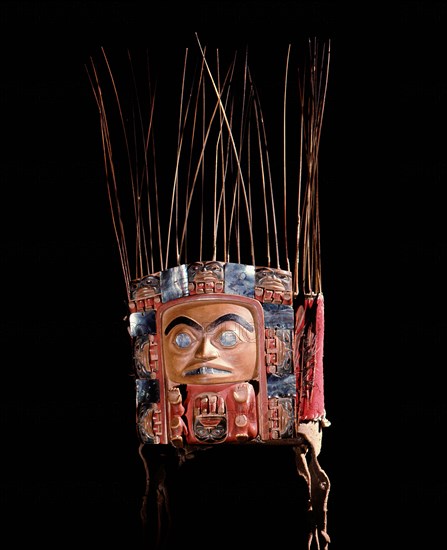 Frontlet with a human figure surrounded by seven smaller figures interspersed with abalone shell