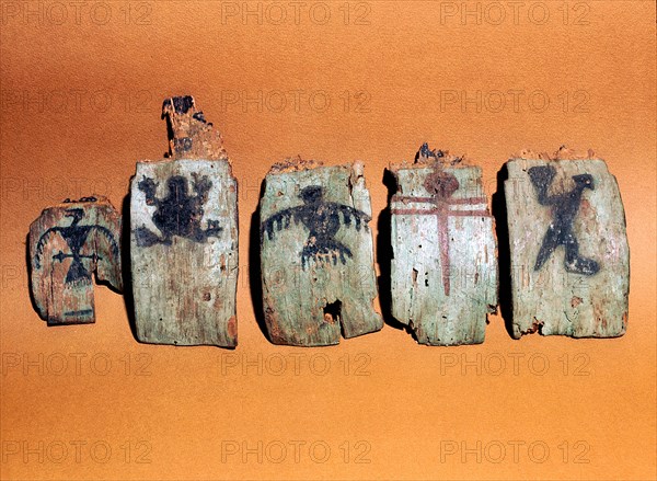 Fragmentary wooden sections from a shamans headdress, painted with images including a frog and two birds