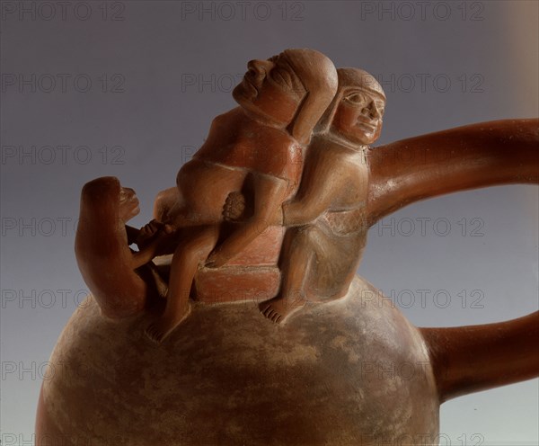 Mochica stirrup spouted jar showing birth scene