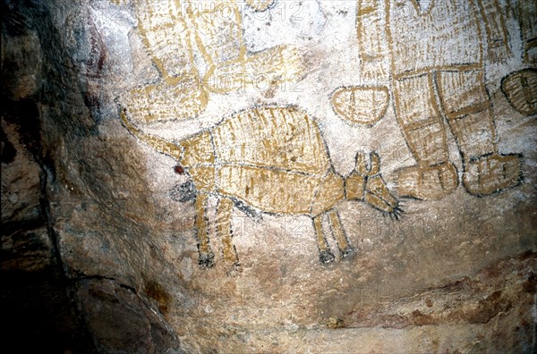 Aboriginal cave painting of men smoking pipes and a Thylacine a now extinct marsupial wolf, more commonly known as Tasmanian tiger