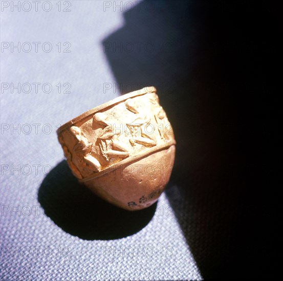 Small unglazed bowl with relief desing of bound prisoners