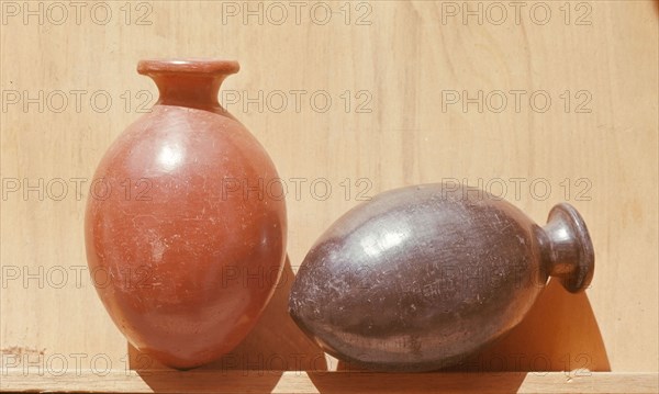 Two small burnished red ware and black ware vessels