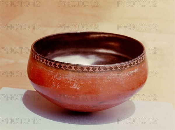 Burnished red ware bowl with lozenge decorated rim