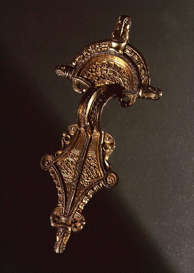 Brooch richly decorated with animals, human beings and gilt details