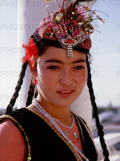 Uygur girl, a professional dancer dressed for the grape harvest dance