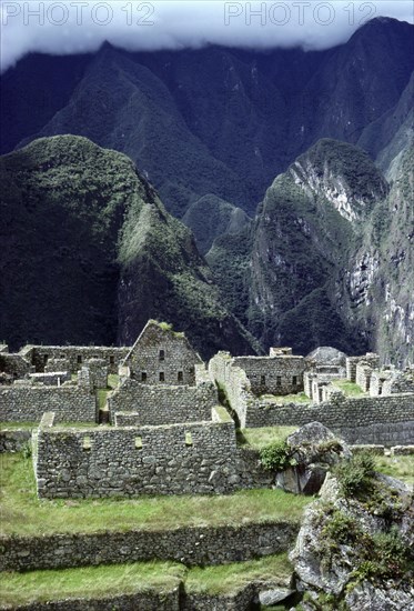 View of Machu Picchu buildings and Cloud Forest beyond