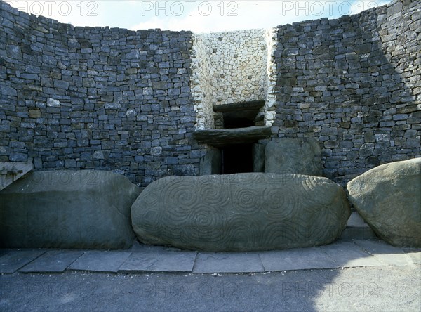 The incised entrance stone in front of the mouth of the passage to the burial chamber at Newgrange