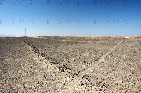 Five Nazca lines - little more that a set of parallel footpaths - cut through the stone-lined border of an earlier and larger line