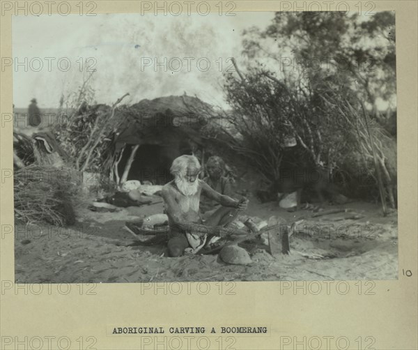 Aboriginal man carving a boomerang