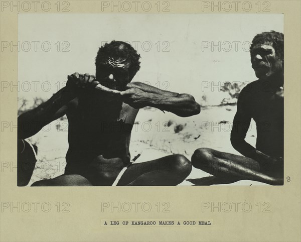 Aboriginal man eating kangaroo leg