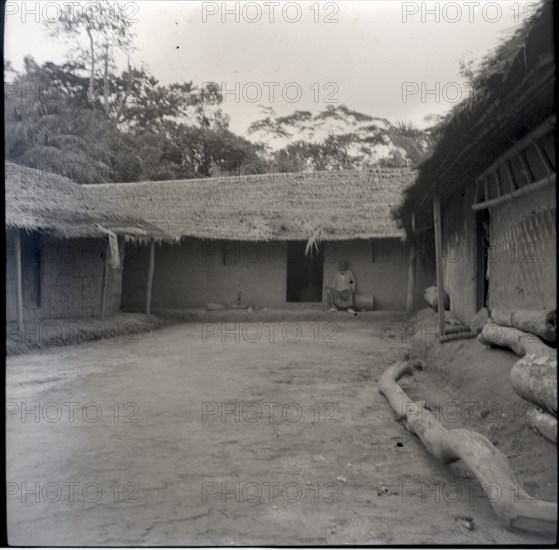 [Tabogo?] sitting in compound