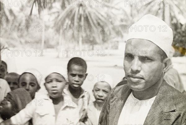 Surahi man with group of children