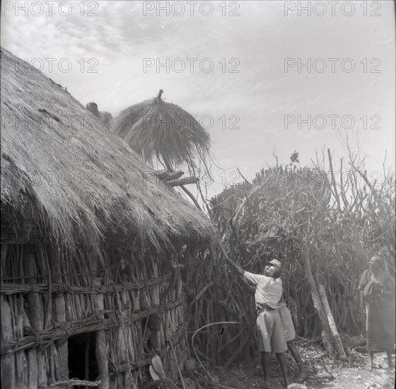 Isubo: Roof of small house being thrown up