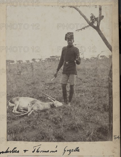 Uniformed servant with dead Thomson's gazelle