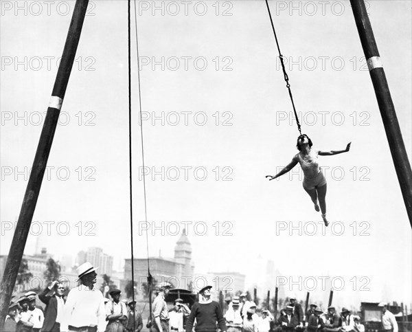 Woman Swings With Her Teeth