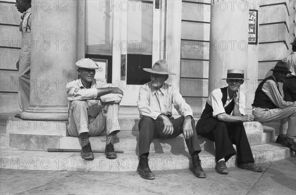 Men Sitting On Bank Steps