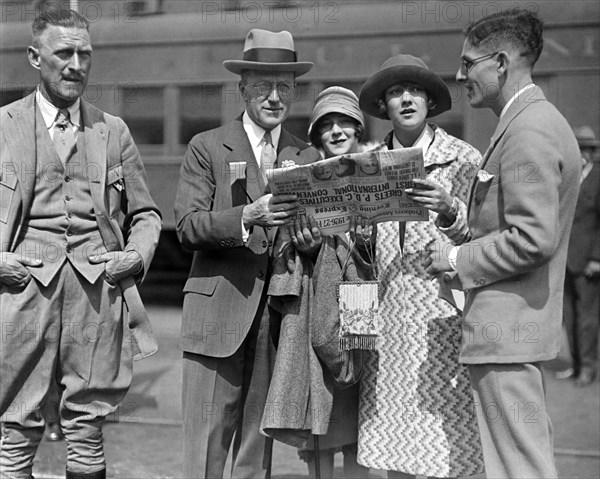 People Reading A Newspaper