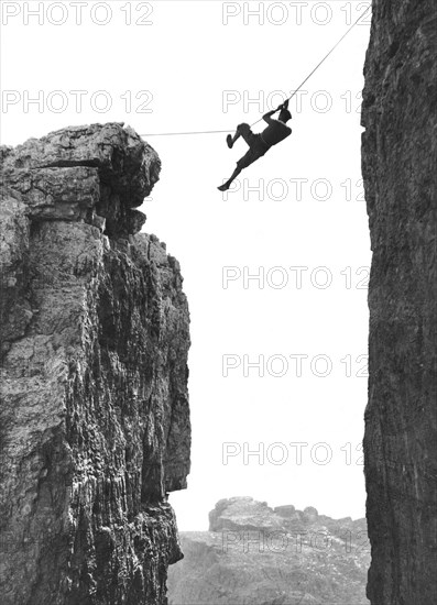 Climber Crossing On A Rope