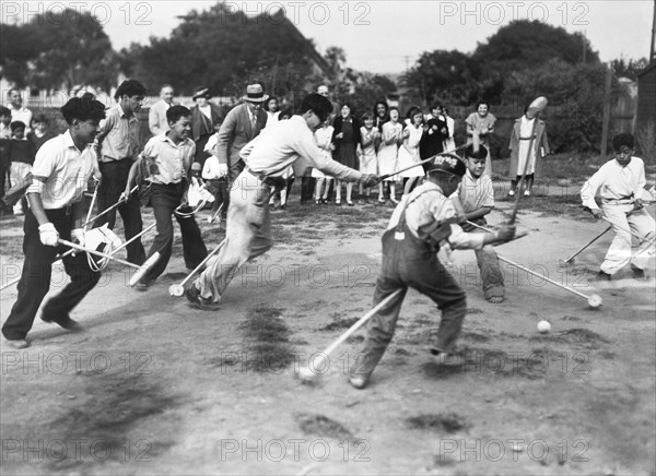 Children Play Broomstick Polo