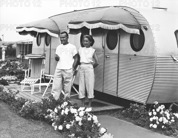 A Couple Beside Their Trailer