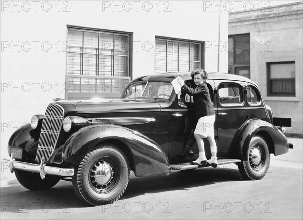 Boy Cleaning A Car