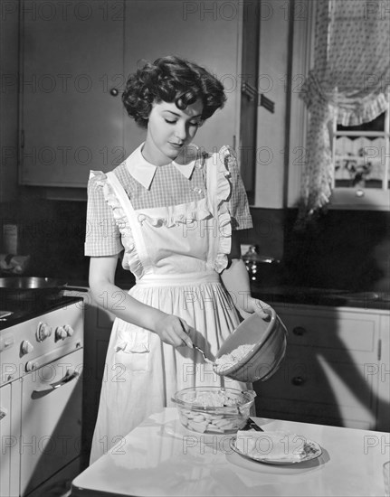 Hollywood, California:  1942.
Actress Marsha Hunt prepares apple cobbler in her kitchen. She was blacklisted during the 1940's and 50's for her First Amendment stands.