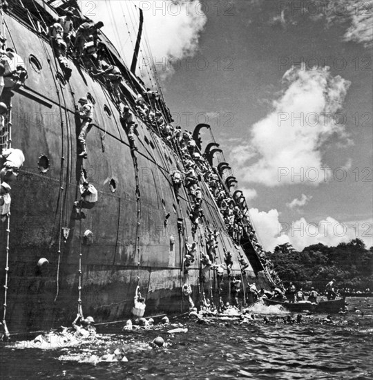 The troop carrier, USS President Coolidge goes down in the harbor at Espiritu Santo in the South Pacific after hittng a friendly mine.