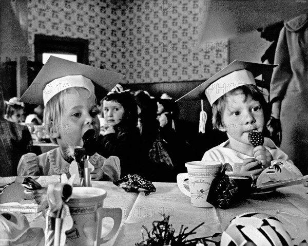 Young children celebrating a graduation ceremony at Fun-Tier Town at Playland At The Beach in San Francisco.