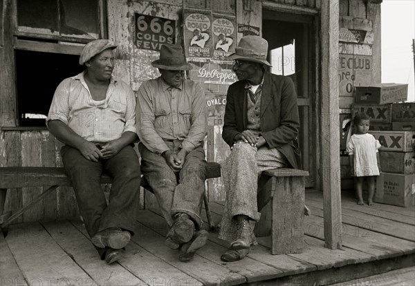 African American hold a conversation unaware of infant girl nearby 1938