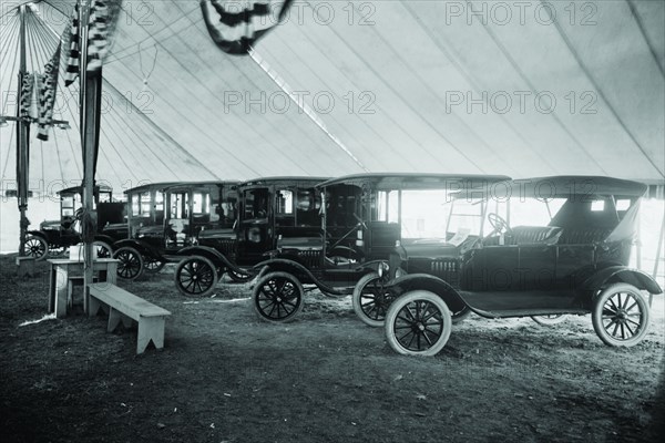 Automobiles on Display in Tent Under American Flag Banners 1921