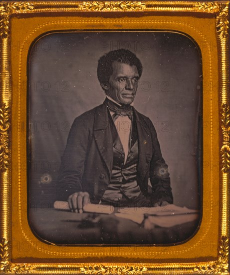 Beverly Page Yates, half-length portrait, facing slightly right, seated at table, holding rolled piece of paper 1857